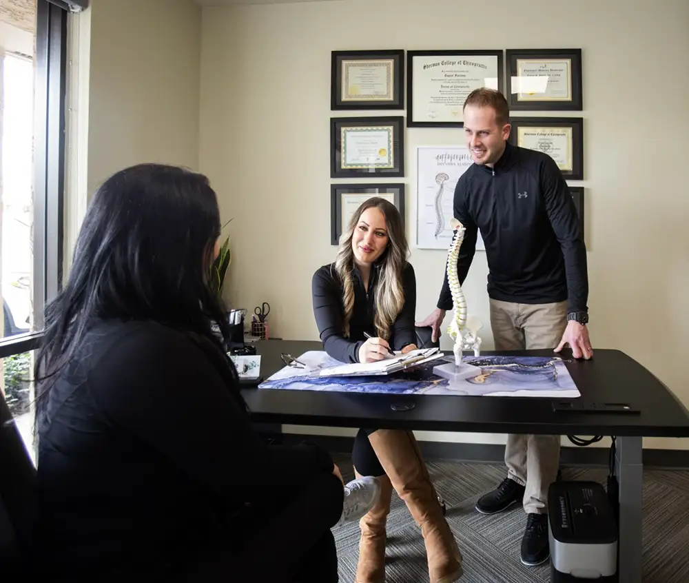 Family-owned Scottsdale chiropractic team discussing treatment plans
